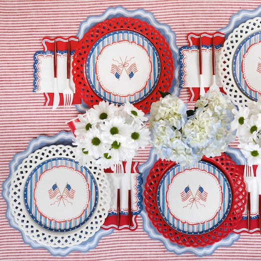 Decorative tableware with red, white, and blue theme on a striped background